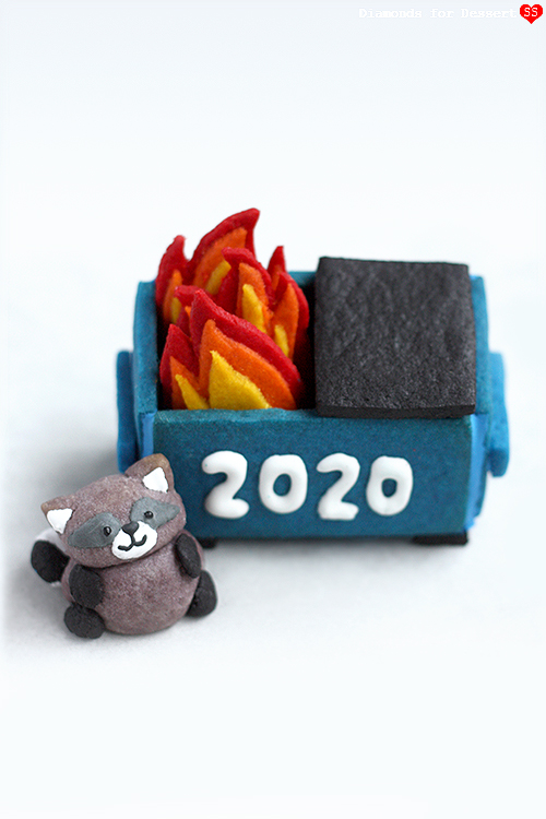 Blue dumpster cookie iced 2020 with red-orange-yellow flame cookies and a small raccoon figure